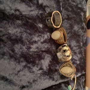 5 silver rings along with one beaded black and white one.